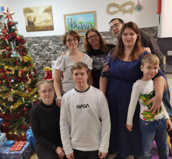 Familienfoto vor einem geschmückten Christbaum